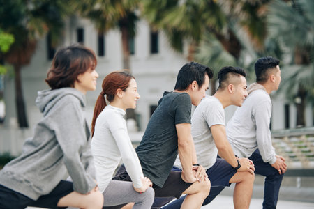 Young people doing deep lunges
