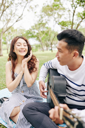 Woman applauding singing boyfriend