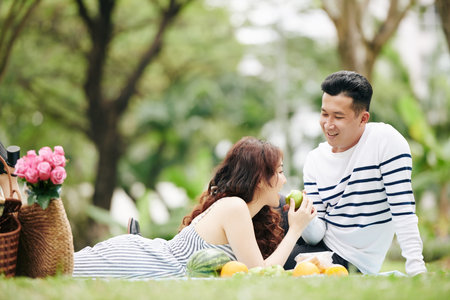 Couple eating fruits at picnic
