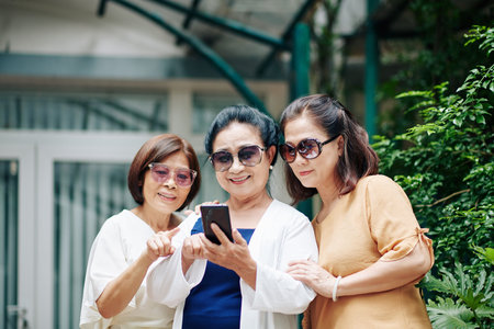 Elderly women checking photos on social media