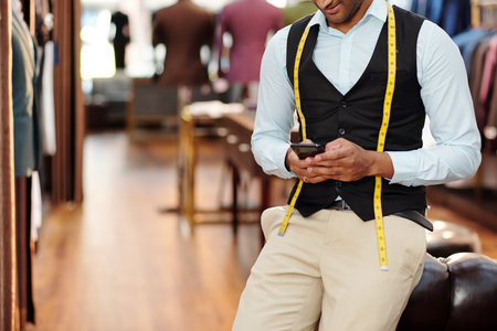 Tailor checking smartphoneの写真素材