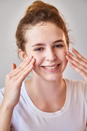 Girl applying moisturizing lotion
