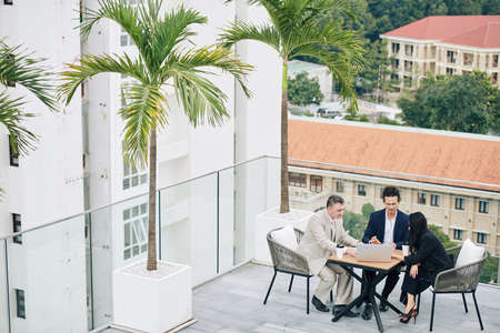Business people meeting on rooftopの写真素材