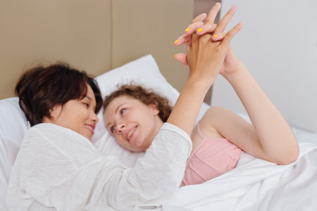 Girlfriends in love cuddling in bed