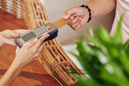Receptionist holding payment terminal