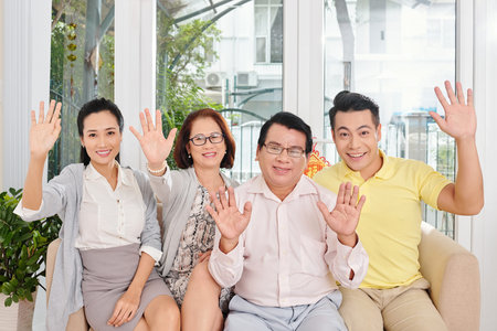 Happy family waving with hands
