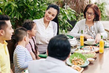 Asian family enjoying dinnerの写真素材