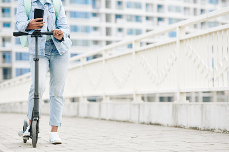 Woman standing on electric scooter