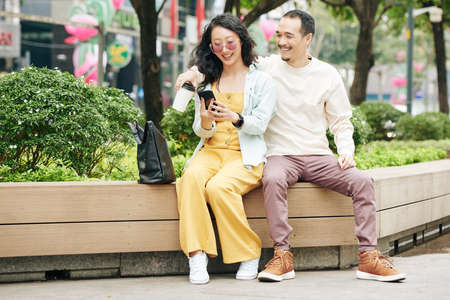 Chinese couple sitting on benchの写真素材
