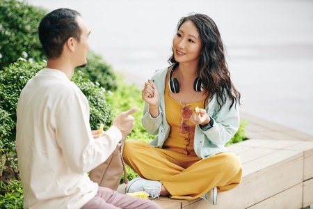 Couple eating snack outdoors