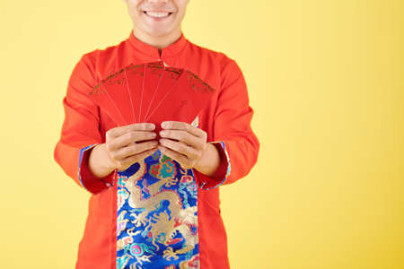 Man giving lucky money envelopesの写真素材