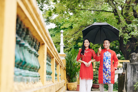Couple walking with umbrella