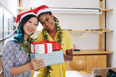 Women posing with Christmas presentsの写真素材