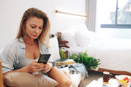 Pretty young woman textingの写真素材