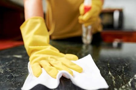 Housewife cleaning kitchen counterの写真素材