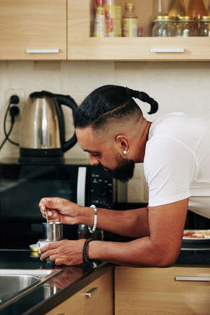 Man using Vietnamese coffee filterの写真素材