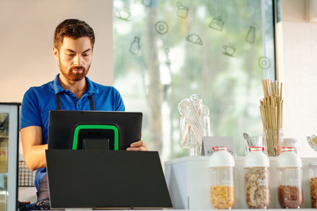 Barista using cash registerの写真素材