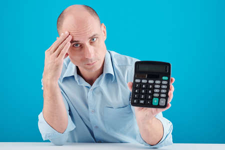 Man showing calculatorの写真素材