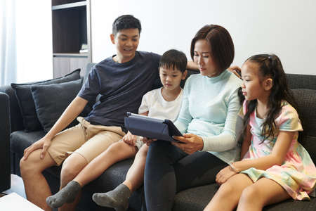Family resting in sofaの写真素材