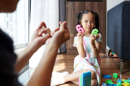 Father teaching daughter countingの写真素材