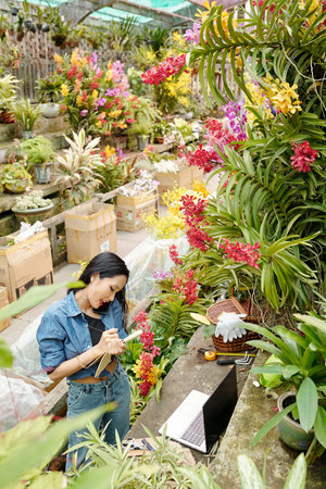 Greenhouse worker talking on phone