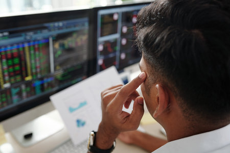 Pensive trader analyzing chart and thinking what stock to buy when market is opened