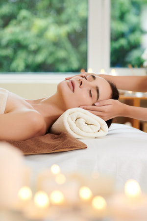 Close-up of woman relaxing during spa massage in spa salonの写真素材