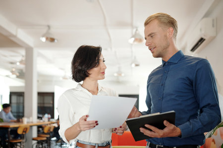 Business executive talking to head of sales department about latest report after meeting