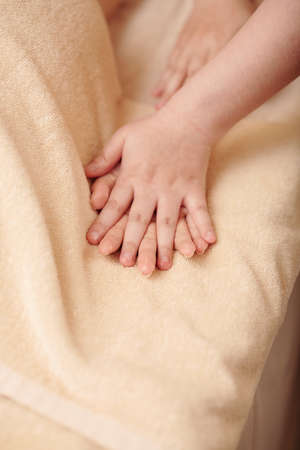 Close-up image of masseuse massaging hands of young woman, pleasure and healthcare conceptの写真素材