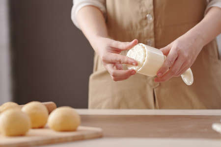 Close-up image of woman preparing plastic form for making mooncakes for mid autumn seasonの写真素材