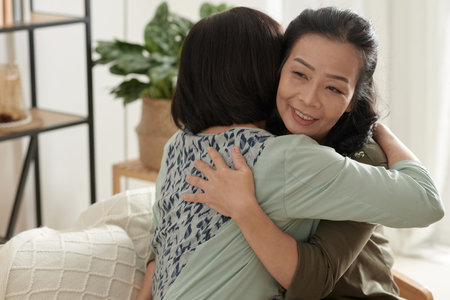 Smiling senior woman hugging her best friend to support her and express loveの写真素材