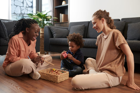 Mother spending time with son playing with wooden toys on the floor at home