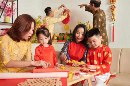 Big family making decorations for celerating Lunar New year at homeの写真素材