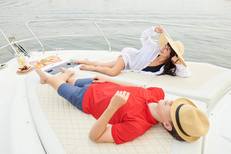 Young couple enjoying romantic sailing getaway on luxurious yacht