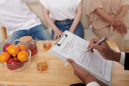 Insurance agent helping family to fill life insurance claim form for every family memeber