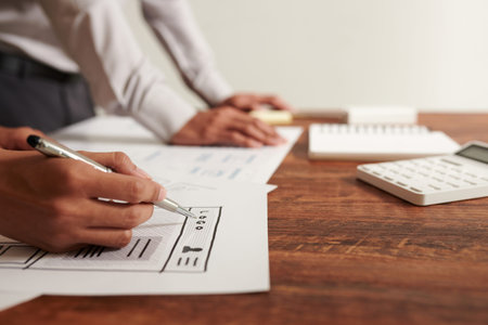 Hands of UI designer drawing wireframe of website or mobile application