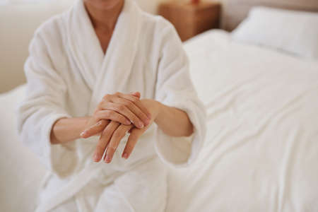 Close-up image of young woman applying moisturizing hand creamの写真素材