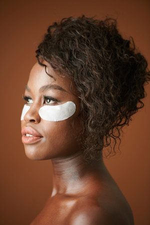 Face of young woman with undereye patches on face that help to get rid of dark circlesの写真素材