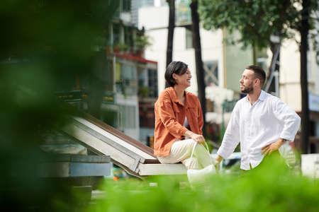 Happy friends laughing and fooling around when spending sunny day in parkの写真素材