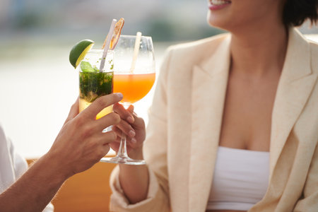 Closeup image of party guests toasting with glasses of sweet delicious cocktailsの写真素材