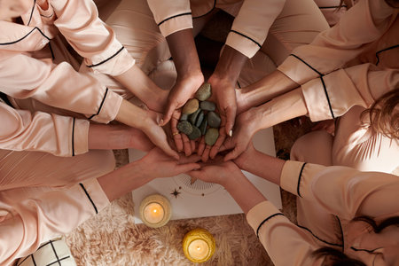 Hands of young women holding small pebble they use for divination