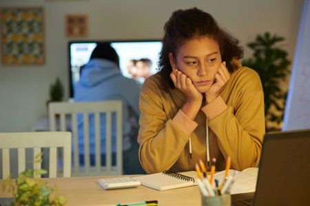 Stressed tired schoolgirl worrying about upcoming exam after studying all night long