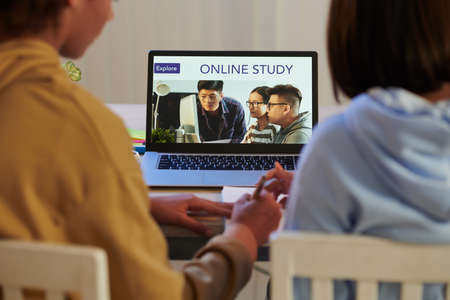 Schoolgirls attending online classes via education platformの写真素材