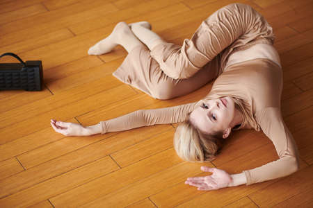 Young female contemporary dancer performing to music in portable speakerの写真素材