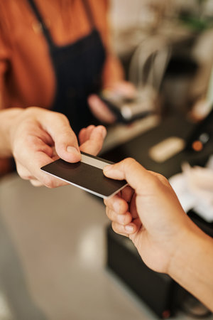 Customer giving credit card to basta to pay for drink