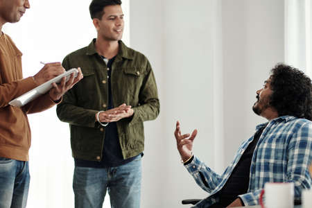 Team of developers discussing ideas during daily brainstorming sessionの写真素材