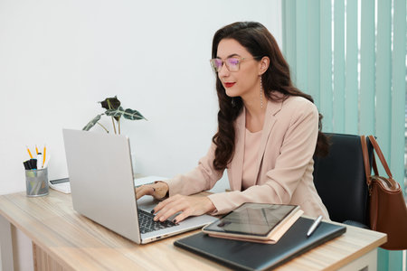 Smiling elegant human resources manager working on laptop at home