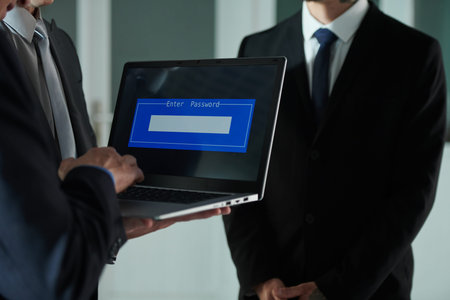 Businessman with laptop entering password to get access to secret documents