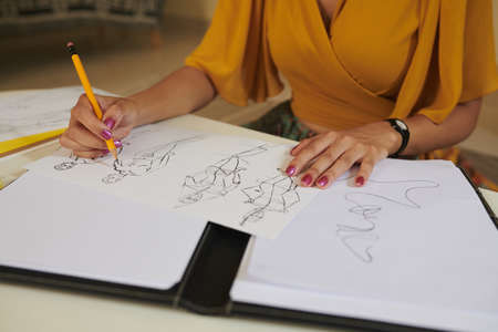 Closeup image of talented designer drawing fashion sketchesの写真素材