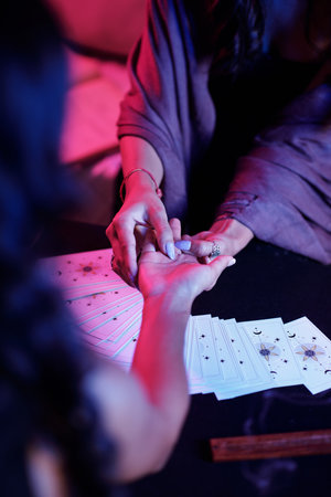 Closeup image of seeker interpretating lines on palm of female clientの写真素材